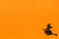 万圣节背景黑色的纸女巫橙色背景快乐万圣节概念空间为文本前视图模型布局平躺万圣节背景黑色的纸女巫橙色背景