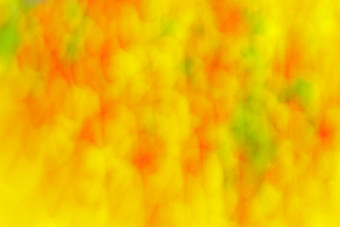 摘要背景点和污渍幻想模式黄色的橙色和绿色颜色背景与领带染料效果和条纹效果定向模糊运动效果