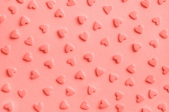 爱浪漫的模式粉红色的糖果心洒粉红色的背景纹理珊瑚健美的爱浪漫的模式粉红色的糖果心洒粉红色的背景纹理珊瑚健美的