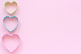 色彩斑斓的刀具饼干心形状柔和的粉红色的背景概念情人节rsquo卡前视图复制空间为文本色彩斑斓的刀具饼干心形状柔和的粉红色的背景概念情人节rsquo卡前视图复制空间为文本