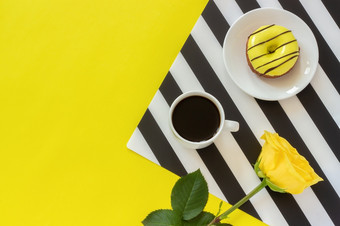 杯咖啡甜甜圈板和黄色的玫瑰时尚的黑色的和白色餐巾黄色的背景最小的风格概念好早....一天平躺前视图复制空间杯咖啡甜甜圈板和黄色的玫瑰时尚的黑色的和白色餐巾黄色的背景最小的风格概念好早....一天平躺前
