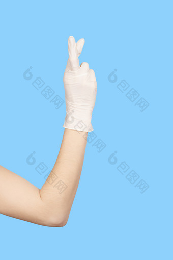 手手势手白色乳胶手套显示手指交叉标志孤立的蓝色的背景希望概念手白色乳胶手套显示手指交叉标志孤立的蓝色的背景