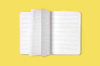 空白开放办公室记事本笔记本与翻转页面孤立的黄色的背景模拟前视图空白开放办公室记事本笔记本与翻转页面孤立的黄色的背景模拟前视图