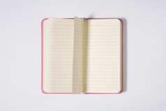 粉红色的空白开放办公室记事本笔记本与翻转页面孤立的白色背景模拟前视图粉红色的空白开放办公室记事本笔记本与翻转页面孤立的白色背景模拟前视图