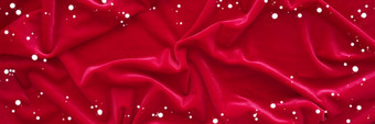 圣诞节背景红色的皱巴巴的天鹅绒织物和雪周围的边缘