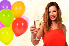 庆祝活动事件概念年轻的和有吸引力的女人红色的衣服与完美的指甲持有玻璃香槟酒和微笑聚会，派对装饰背景混合