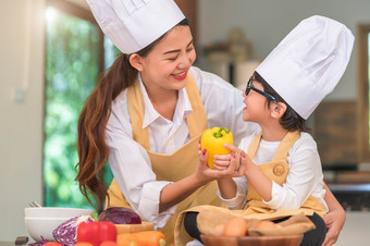 快乐<strong>美丽</strong>的亚洲女人和可爱的小男孩与眼镜准备烹饪厨房首页<strong>人生</strong>活方式和家庭自制的食物和成分概念两个泰国看每一个其他