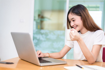 亚洲女人享受自己而使用笔记本电脑和互联网办公室业务和市场营销和部分时间概念行<strong>购物</strong>和业务成功<strong>主题</strong>快乐情绪做工作工作