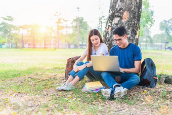 两个亚洲年轻的大学人讨论关于家庭作业和最后检查为测试与移动PC教育和友谊概念幸福和学习概念情人和朋友主题