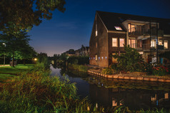 美丽的晚上荷兰可爱的荷兰房子运河和裤子反射