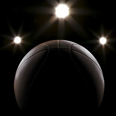 篮球特写镜头黑色的背景与散景聚光灯