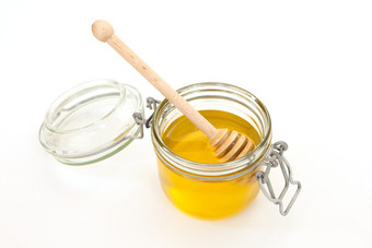 蜂蜜Jar与木坚持为蜂蜜白色背景概念健康的食物蜂蜜就像超级食物极简主义风格