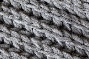 针织羊毛变形表面宏软灰色美利奴羊毛模式背景特写镜头秋天和冬天平躺斯堪的那维亚最小的风格