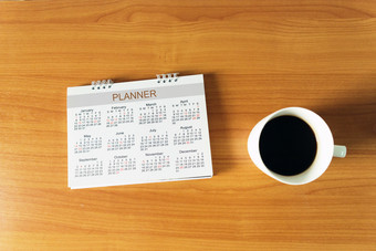 旅行规划日历和使用便利贴为请注意与杯咖啡木表格