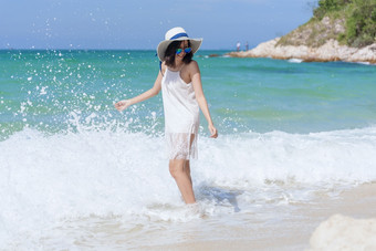 夏天时间女人假期的海滩快乐的女人穿夏天衣服和稻草帽子坐着的海滩看海时间放松夏天生活方式户外拍摄热带岛海滩
