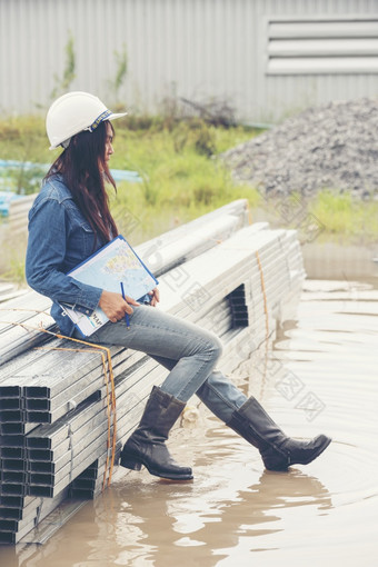 女人建设工程师穿安全白色硬他建设网站行业工人女工程师工人民事工程与硬他安全头盔女人建设工程师概念