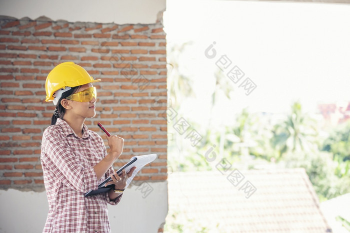 女人建设工程师穿安全白色硬他建设网站行业工人女工程师工人民事工程与硬他安全头盔女人建设工程师概念