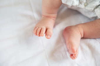 小脚新生儿婴儿的床上前视图的概念母亲母乳喂养小脚新生儿婴儿的床上前视图的概念母亲母乳喂养