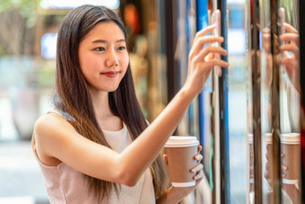 亚洲年轻的女人手使用聪明的移<strong>动</strong>电话扫描的电影票机为买和得到的优<strong>惠</strong>券部门商店生活方式和休闲娱乐和技术扫描仪概念