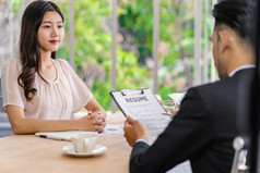 年轻的亚洲女人研究生面试与两个经理与积极的运动会议房间业务招聘新成员工作面试与经理概念