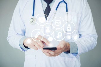 医生使用智能手机和健康哪图标背景医院病房