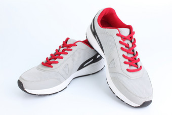 灰色的<strong>运动鞋</strong>与红色的鞋带白色<strong>背景</strong>