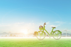 绿色自行车和全球风涡轮场与蓝色的天空背景环境友好的概念