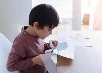 小学生使用剪刀<strong>切割形状</strong>鱼为家庭小孩学习如何钝纸孩子保持首页享受艺术和工艺品活动在新冠病毒封锁首页学校玩和学习