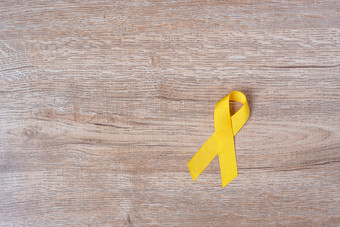 <strong>自杀预防</strong>和童年癌症意识黄色的丝带为支持人生活和疾病孩子们医疗保健和<strong>世界</strong>癌症一天概念