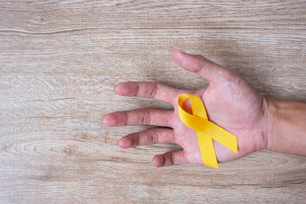 自杀<strong>预防</strong>和童年癌症意识黄色的丝带为支持人生活和<strong>疾病</strong>孩子们医疗保健和世界癌症一天概念