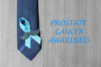 前列腺癌癌症意识光蓝色的丝带与胡子和领带为支持人生活和疾病但医疗保健和世界癌症一天概念