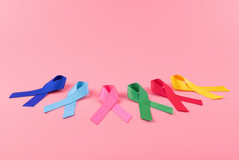 世界癌症一天2<strong>月色</strong>彩斑斓的意识丝带蓝色的红色的绿色粉红色的和黄色的颜色木背景为支持人生活和疾病医疗保健和医学概念