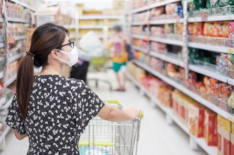 亚洲女人穿保护面具和购物超市杂货店保护冠状病毒变形社会距离新正常的和生活后新冠病毒流感大流行
