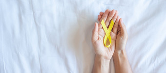 自杀预防肉瘤骨膀胱童年癌症意识月黄色的丝带为支持人生活和<strong>疾病</strong>孩子们医疗保健和<strong>世界</strong>癌症一天概念