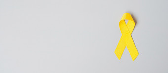 自杀预防肉瘤骨膀胱童年癌症意识月黄色的丝带为支持人生活和疾病孩子们医疗保健和世界癌症一天概念