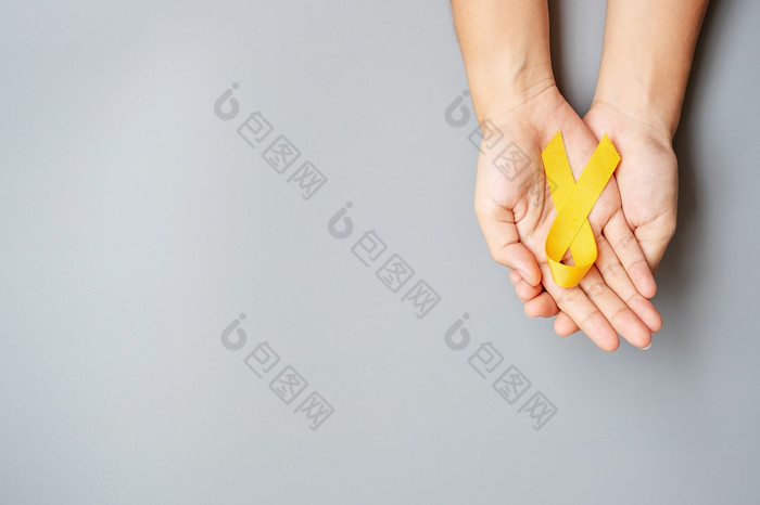 自杀预防肉瘤骨膀胱童年癌症意识月黄色的丝带为支持人生活和疾病孩子们医疗保健和世界癌症一天概念