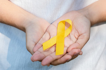 自杀预防肉瘤骨膀胱童年癌症意识月黄色的丝带为<strong>支持人</strong>生活和疾病孩子们医疗保健和世界癌症一天概念