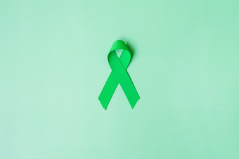 绿色丝带绿色颜色背景为支持人生活和疾病<strong>肝胆</strong>囊甚至管癌症和器官捐赠意识月概念