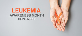 白血病意识月橙色丝带为支持人生活和疾病医疗保健和世界癌症一天概念