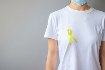 黄色的丝带为支持人生活和疾病9月<strong>自杀预防</strong>一天童年肉瘤和骨癌症意识月概念