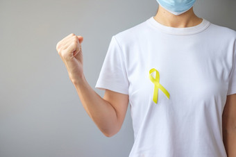 黄色的丝带为支持人生活和疾病9月<strong>自杀预防</strong>一天童年肉瘤和骨癌症意识月概念