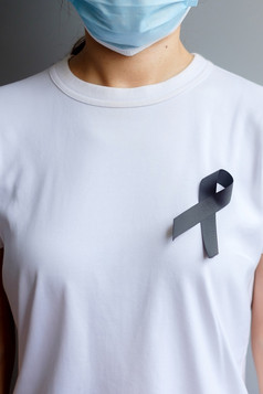 黑色的丝带为黑素瘤和皮肤癌症疫苗受伤意识月悲伤和休息和平医疗保健和种族主义概念