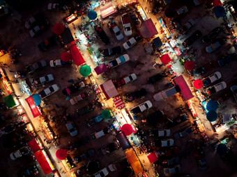 空中视图晚上市场在那里是许多人汽车和商店