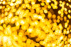 黄色的色彩斑斓的光摘要圆形散景圣诞节树背景装饰在圣诞节和新一年