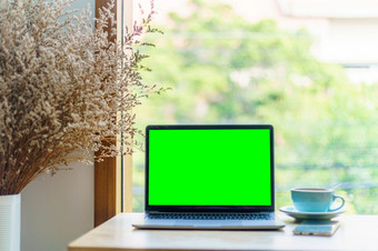 模型移动PC电脑与空屏幕与咖啡杯和智能手机表格的咖啡商店背景<strong>绿色</strong>屏幕