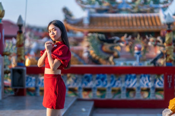 肖像美丽的微笑亚洲年轻的女人穿红色的旗袍衣服传统的装饰为中国人新一年节日庆祝文化中国中国人神社公共的地方泰国