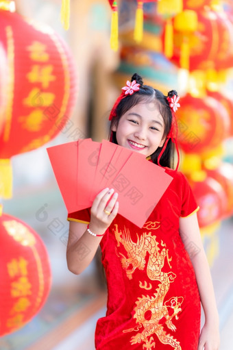 亚洲快乐小女孩穿红色的传统的<strong>中国</strong>人<strong>旗袍</strong>装饰持有红色的信封手和灯笼与的<strong>中国</strong>人文本祝福写《财富》杂志祝福为<strong>中国</strong>人