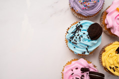 美味的自制的纸杯蛋糕与色彩斑斓的奶油和一流的与糖果和巧克力饼干自制的秋天假期甜点