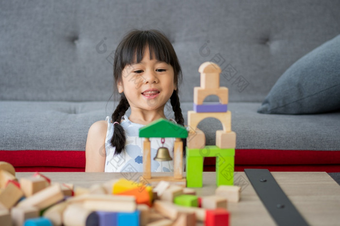 可爱的亚洲小女孩玩与色彩斑斓的玩具块孩子们玩与教育玩具幼儿园托儿所的有创意的玩的孩子发展概念蹒跚学步的孩子的托儿所