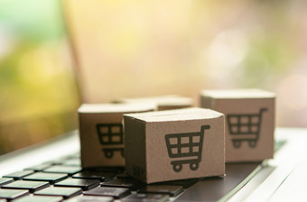 在线购物纸纸箱包裹与购物车标志移动PC键盘购物服务的在线网络和提供了首页交付